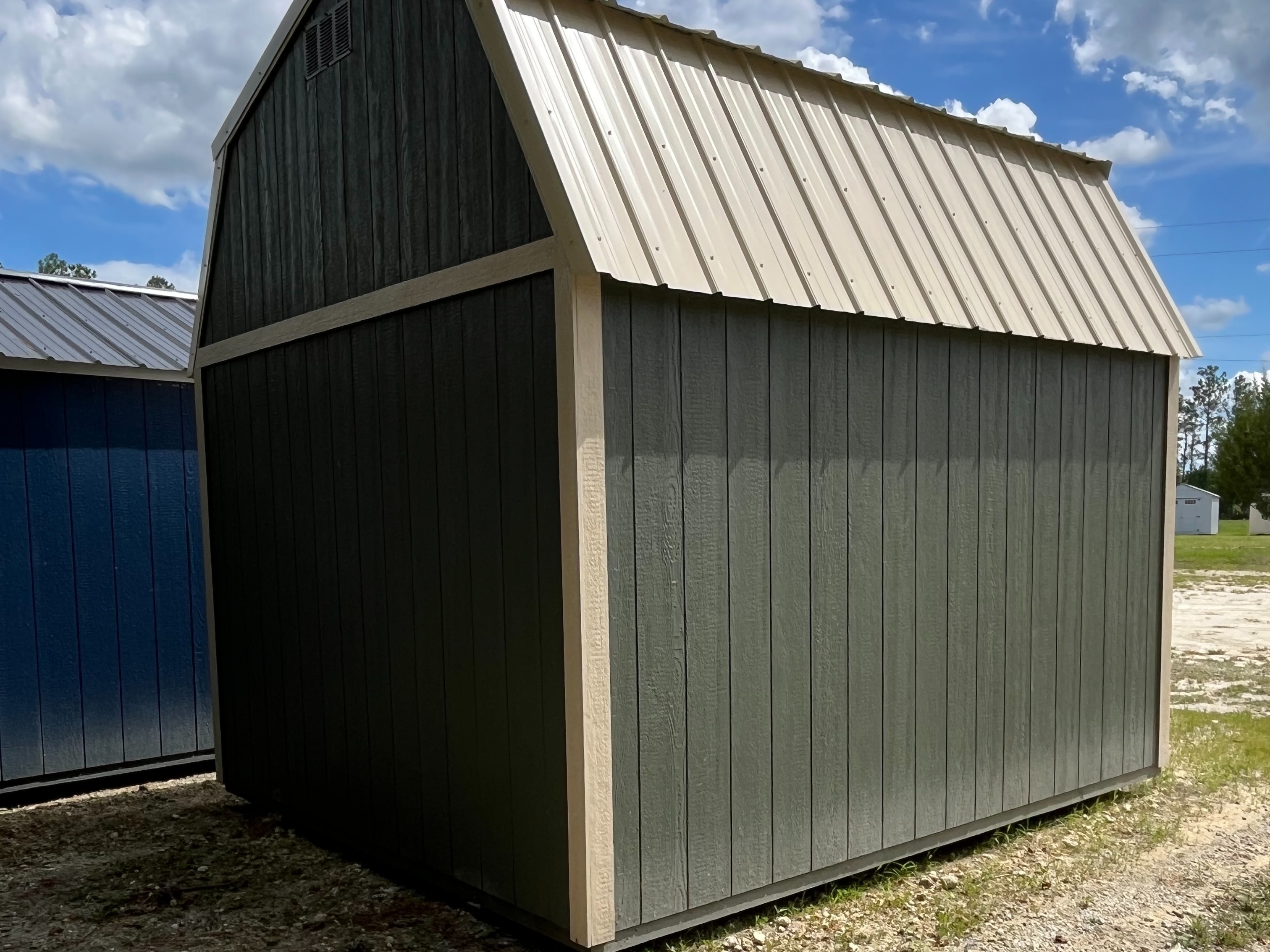 green lofted barn exterior back and right sides with tan trim
