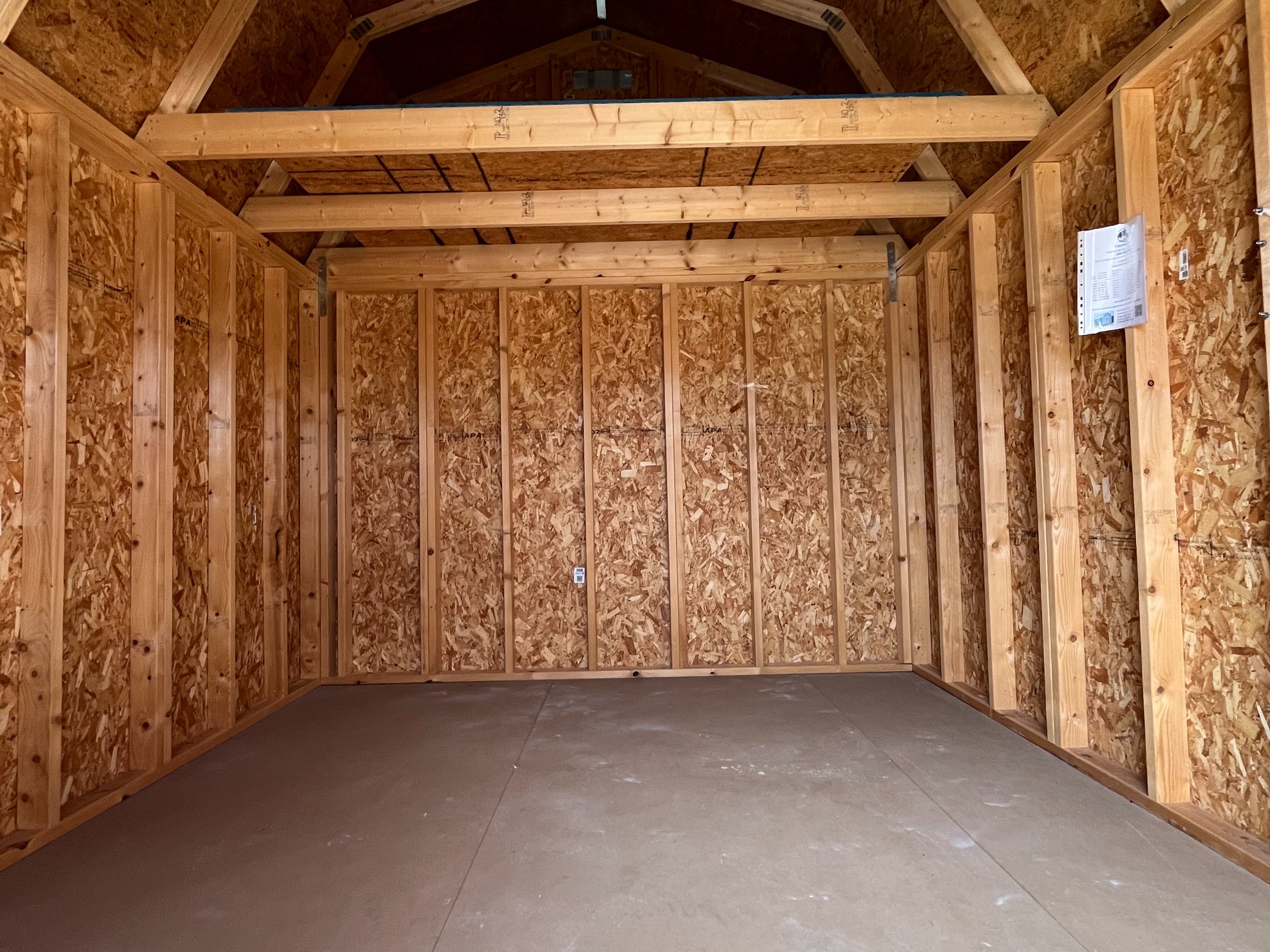 lofted barn interior seen through the double doors with two four foot lofts